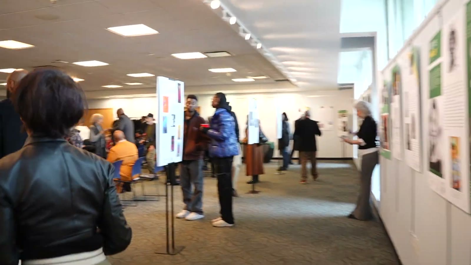 Visitors viewing Greenburgh Black History Museum exhibition panels