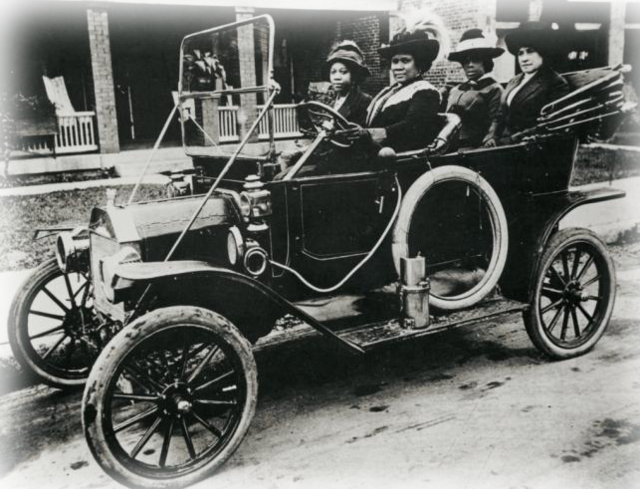 Madam C. J. Walker and companions seated in an early automobile.
